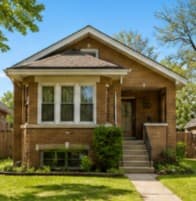 A classic Chicago brick bungalow with offset gable on a residential street